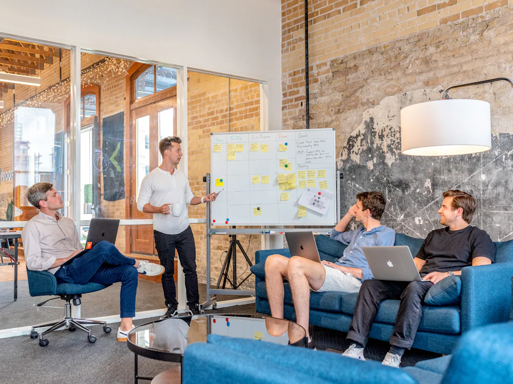 A small team planning at a whiteboard